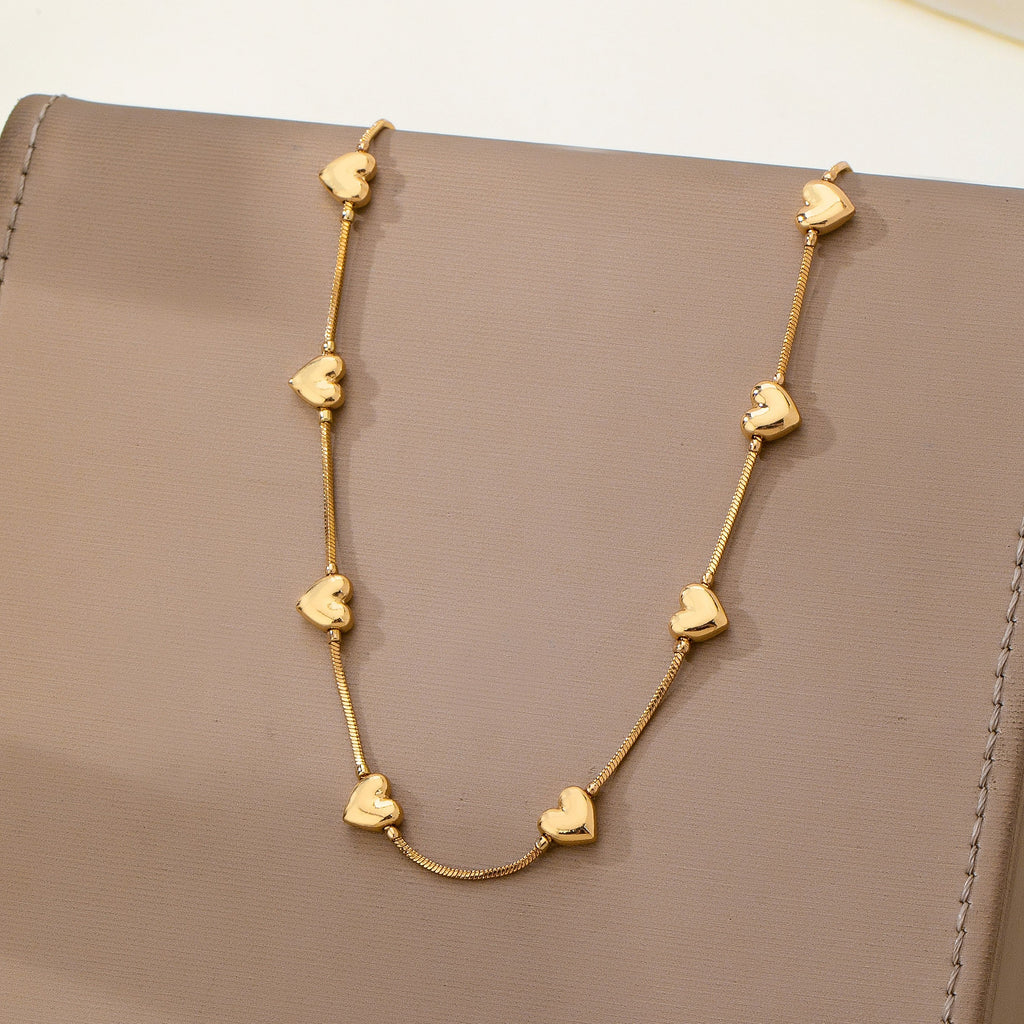 Dainty Gold Puffy Heart Station Necklace | 80N93588